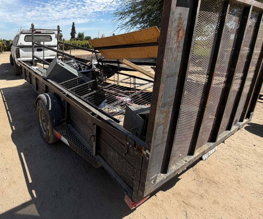 Loaded junk removal trailer hitched to a truck after a hauling job in Fresno, CA